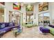 Spacious living room with designer furnishings, travertine floors, and access to outdoor living spaces at 14360 E Desert Cove Ave, Scottsdale, AZ 85259