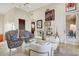 Open-concept living room featuring a mix of patterns, a glass display cabinet, and access to other spaces at 14360 E Desert Cove Ave, Scottsdale, AZ 85259