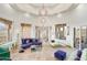 Bright living room featuring large windows with scenic views, stylish seating, and eye-catching light fixtures at 14360 E Desert Cove Ave, Scottsdale, AZ 85259