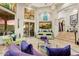 Elegant living room with travertine flooring, stylish decor, and access to the rear patio at 14360 E Desert Cove Ave, Scottsdale, AZ 85259