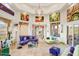 Bright living room featuring stylish decor, travertine floors, and access to an outdoor patio at 14360 E Desert Cove Ave, Scottsdale, AZ 85259