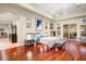 Large main bedroom features hardwood floors, a modern light fixture, and balcony access at 14360 E Desert Cove Ave, Scottsdale, AZ 85259