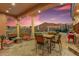 Outdoor patio seating area with mountain views, a fire pit, and dining furniture at 14360 E Desert Cove Ave, Scottsdale, AZ 85259