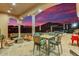 Outdoor patio with stunning sunset views, dining furniture, a bar, and a fire pit at 14360 E Desert Cove Ave, Scottsdale, AZ 85259