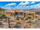 View of the rear exterior featuring a hot tub and a desert landscape with mountain views at 14360 E Desert Cove Ave, Scottsdale, AZ 85259