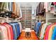 Large walk-in closet with organized shelving and hanging rods for optimal storage at 14360 E Desert Cove Ave, Scottsdale, AZ 85259