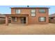 Rear exterior showcasing a spacious yard, covered patio, and various window placements at 14544 W Sierra St, Surprise, AZ 85379