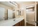 Bright bathroom featuring large vanity, framed mirrors, and walk-in shower at 14544 W Sierra St, Surprise, AZ 85379