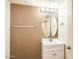 Bathroom featuring a single sink vanity, an oval mirror, and decorative lighting at 14544 W Sierra St, Surprise, AZ 85379