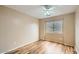 This cozy bedroom features wood floors, neutral paint, and a large sunny window at 14544 W Sierra St, Surprise, AZ 85379