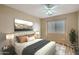 This bedroom features a neutral color palette, wood floors, and a large sunny window at 14544 W Sierra St, Surprise, AZ 85379