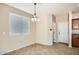 Cozy dining area with a chandelier, tile flooring, and a bright window with blinds at 14544 W Sierra St, Surprise, AZ 85379