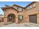 Inviting home with an arched entry, three car garage, and stone accents at 14544 W Sierra St, Surprise, AZ 85379