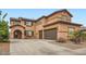 Charming two-story home featuring a three-car garage and desert landscaping at 14544 W Sierra St, Surprise, AZ 85379