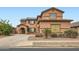 Two-story home showcasing a well-maintained front yard and a covered porch at 14544 W Sierra St, Surprise, AZ 85379