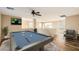Spacious loft with a pool table and mounted tv at 14544 W Sierra St, Surprise, AZ 85379