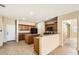 Open kitchen features wooden cabinets, an island, tile flooring, and black appliances at 14544 W Sierra St, Surprise, AZ 85379