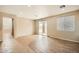 Spacious living room with tile and wood flooring, a sliding glass door, and neutral paint at 14544 W Sierra St, Surprise, AZ 85379