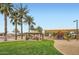 Community playground featuring play structures, picnic tables, and lush landscaping at 14544 W Sierra St, Surprise, AZ 85379
