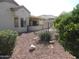 Backyard featuring desert landscaping, and covered patio area at 15104 W Pinehurst W Ln, Surprise, AZ 85374