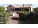 Charming backyard featuring a covered patio, desert landscaping, and decorative rock for low-maintenance appeal at 15104 W Pinehurst W Ln, Surprise, AZ 85374