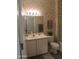 Bathroom with neutral-toned marble wallpaper, large mirror, and a shower and tub combo at 15104 W Pinehurst W Ln, Surprise, AZ 85374
