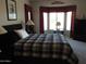Primary bedroom features a large window, a black bed frame, and a black dresser at 15104 W Pinehurst W Ln, Surprise, AZ 85374