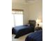 Bedroom with two twin beds, neutral carpet, and large bright window at 15104 W Pinehurst W Ln, Surprise, AZ 85374