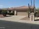 Charming single-story home with a two-car garage and mature desert landscaping at 15104 W Pinehurst W Ln, Surprise, AZ 85374