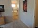 Hallway view of the bathroom with dual sinks and neutral paint at 15104 W Pinehurst W Ln, Surprise, AZ 85374