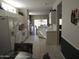 Bright and airy kitchen open to dining area with white cabinetry at 15104 W Pinehurst W Ln, Surprise, AZ 85374