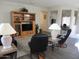 Inviting living room with wood-style flooring, entertainment center, and comfortable seating at 15104 W Pinehurst W Ln, Surprise, AZ 85374