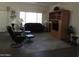 Inviting living room with wood-style flooring, entertainment center, and comfortable seating at 15104 W Pinehurst W Ln, Surprise, AZ 85374