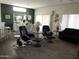 Comfortable living room with two swiveling easy chairs, a neutral area rug, and open access to the dining area at 15104 W Pinehurst W Ln, Surprise, AZ 85374