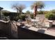 Outdoor patio area with dining set and meticulous desert landscaping at 15104 W Pinehurst W Ln, Surprise, AZ 85374