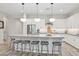 Bright kitchen features an island with bar stool seating and modern appliances at 15998 W Electra Ln, Surprise, AZ 85387