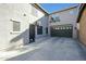 Spacious backyard with gray concrete, basketball hoop, and access to the garage at 18841 E Pelican Ct, Queen Creek, AZ 85142