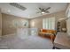 Bright room featuring a ceiling fan, large windows, and neutral color palette at 18841 E Pelican Ct, Queen Creek, AZ 85142