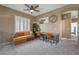 Cozy room featuring a ceiling fan, a long desk, large windows, and neutral color palette at 18841 E Pelican Ct, Queen Creek, AZ 85142