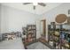 room featuring a ceiling fan, decorative shelving, and neutral color palette with a grey rug at 18841 E Pelican Ct, Queen Creek, AZ 85142