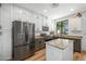 Bright kitchen with white cabinets, stainless steel appliances, and a central island at 18841 E Pelican Ct, Queen Creek, AZ 85142