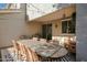 Covered patio with an oversized dining table, comfortable seating, and string lights at 18841 E Pelican Ct, Queen Creek, AZ 85142