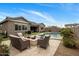 Inviting backyard with in-ground pool, patio, fire pit and lounge seating at 20040 E Kestrel St, Queen Creek, AZ 85142
