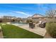Large backyard with in-ground pool, artificial turf, fire pit and seating at 20040 E Kestrel St, Queen Creek, AZ 85142