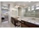 Well-lit bathroom with double sinks, granite counters, large mirrors, and a walk-in tiled shower at 20040 E Kestrel St, Queen Creek, AZ 85142