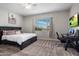 Cozy bedroom features a comfortable bed, a desk, a window with natural light, and contemporary decor at 20040 E Kestrel St, Queen Creek, AZ 85142