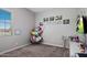 Cozy bedroom with plush carpeting, whimsical hammock chair, and charming 'Annabelle' decor at 20040 E Kestrel St, Queen Creek, AZ 85142