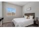 Inviting bedroom features a comfortable bed with white quilt, rustic headboard and soothing decor at 20040 E Kestrel St, Queen Creek, AZ 85142