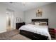 Spacious bedroom with a queen-size bed, a dark wood dresser, and a tranquil ambiance at 20040 E Kestrel St, Queen Creek, AZ 85142