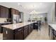 Open kitchen with large island, stainless steel appliances, and eat-in breakfast bar at 20040 E Kestrel St, Queen Creek, AZ 85142